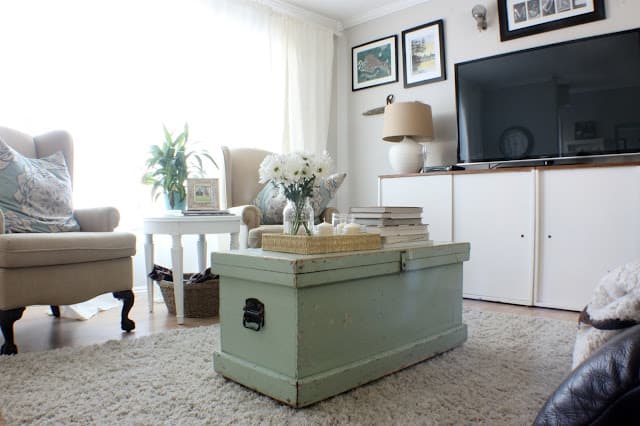 A Swift Current makeover - antique chest used a coffee table and well as the tv and gallery wall.