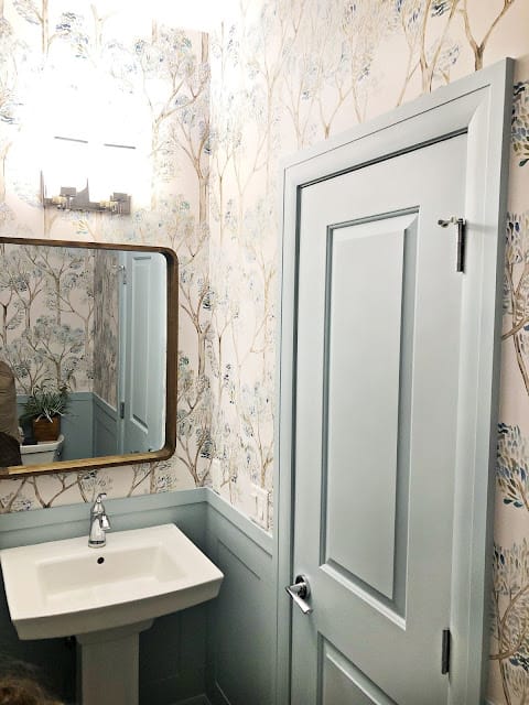 Small powder room makeover painted door and panelling.