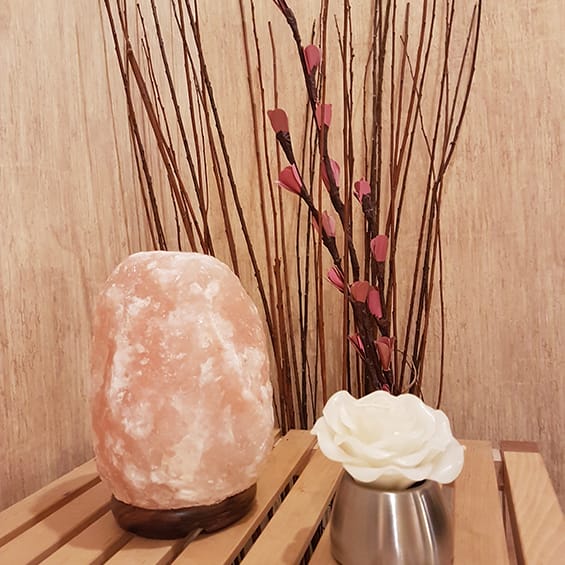 Himalayan salt lamp, massage oil and decorative flowers, taken at the west edmonton clinic